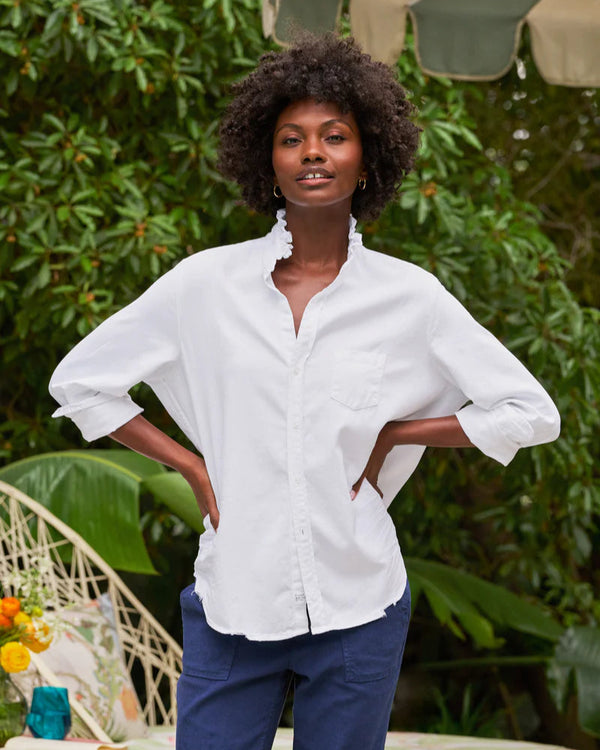 woman wearing Frank & Eileen Eileen Ruffle in White standing outdoors with greenery in the background