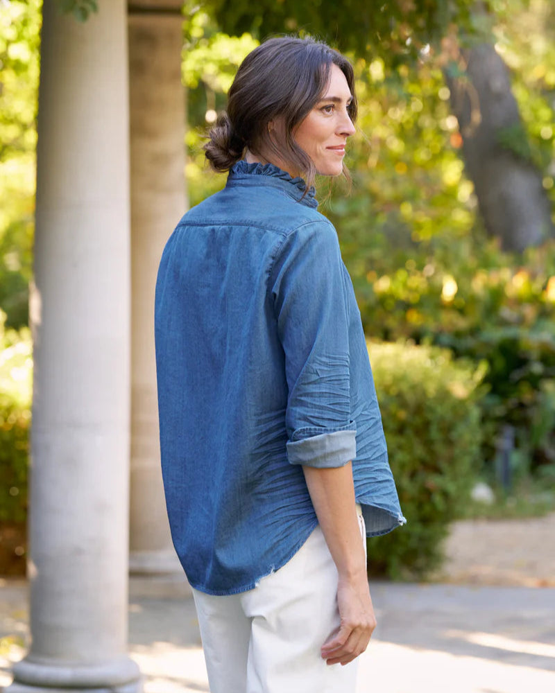 Woman wearing Woman wearing Frank & Eileen Eileen Ruffle in Vintage Stonewashed Indigo outdoors with greenery and a column in the background