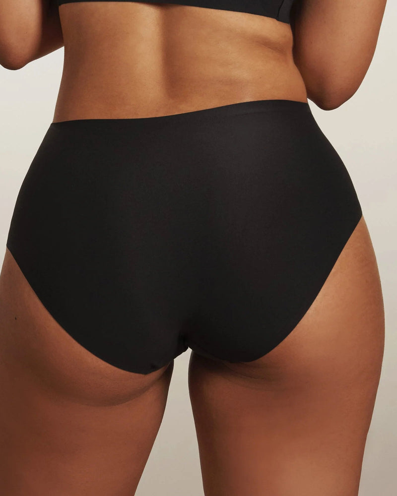 woman wearing Evelyn & Bobbie High Waisted Retro Bikini in Black on white background backview