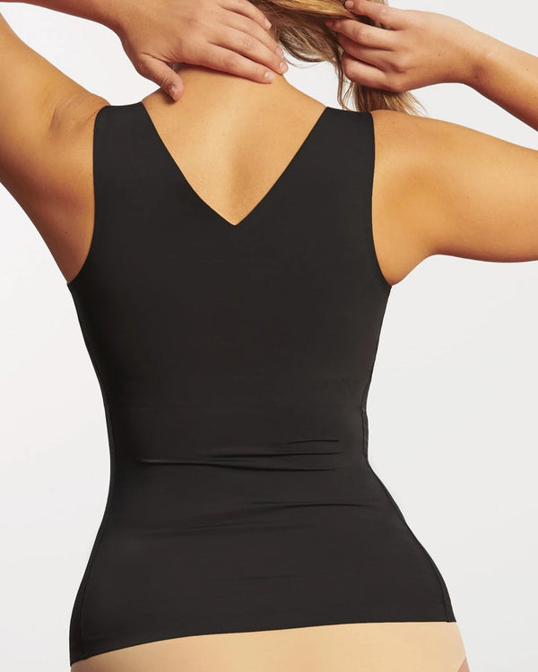 Woman wearing Evelyn & Bobbie Defy Bra Tank in Black against a plain background backview