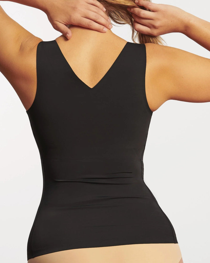 Woman wearing Evelyn & Bobbie Defy Bra Tank in Black against a plain background backview