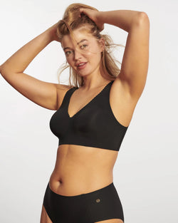 Woman wearing Evelyn & Bobbie The Evelyn Bra in Black on a white background