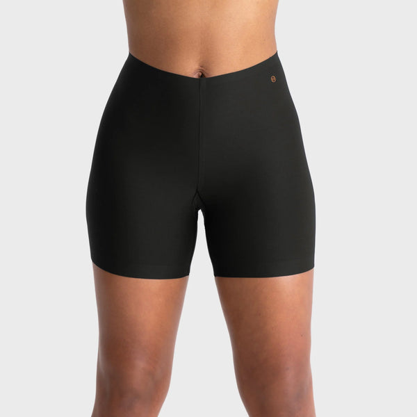woman wearing a gray hoodie and Evelyn & Bobbie Longline Girlshort/Slip Short in Black against a white background