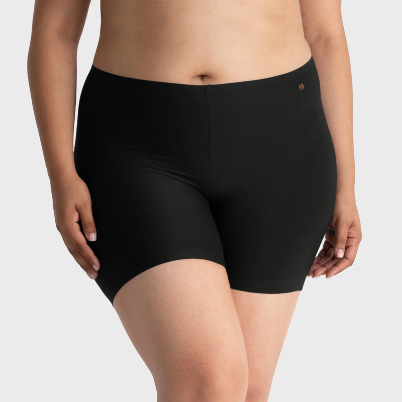 woman wearing a gray hoodie and Evelyn & Bobbie Longline Girlshort/Slip Short in Black against a white background