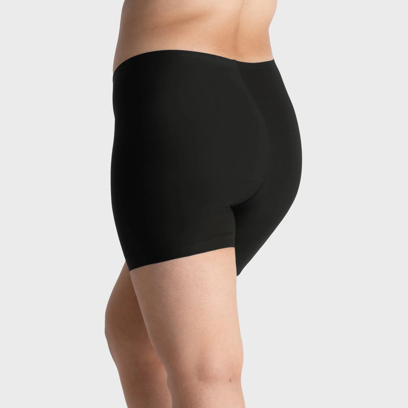 woman wearing a gray hoodie and Evelyn & Bobbie Longline Girlshort/Slip Short in Black against a white background backview
