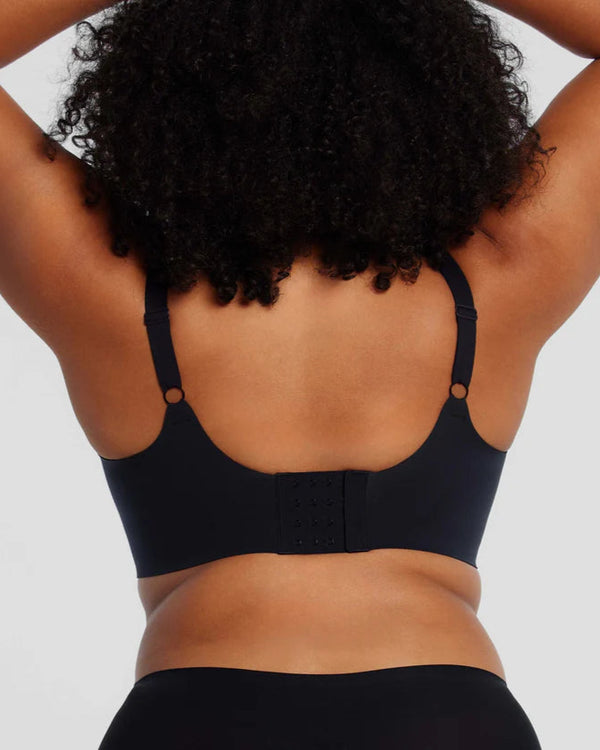 woman wearing Evelyn & Bobbie Starlette Plunge Bra in Black white background backview