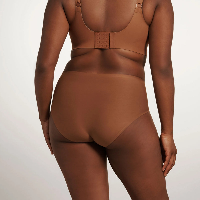 woman wearing Evelyn & Bobbie High Waisted Retro Bikini in Clay on white background backview