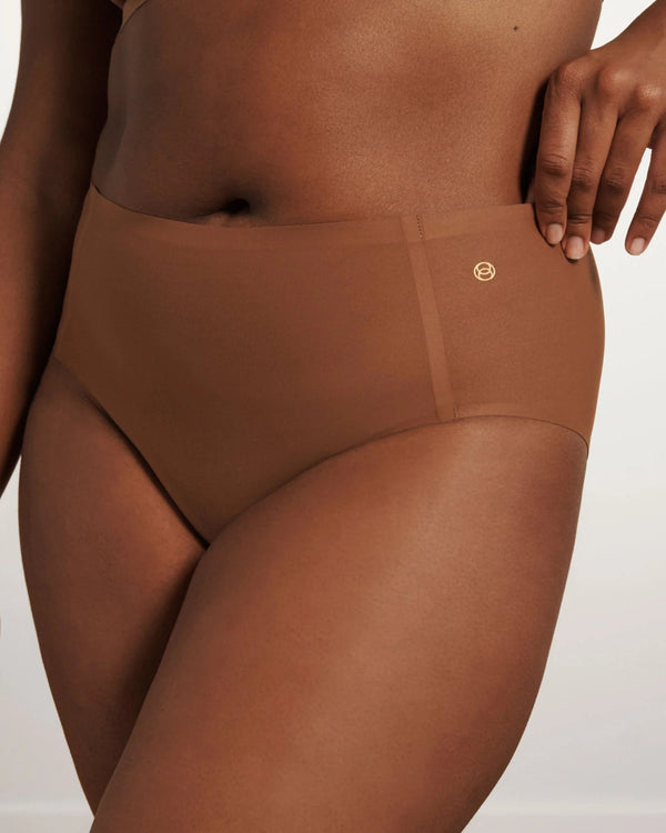 woman wearing Evelyn & Bobbie High Waisted Retro Bikini in Clay on white background