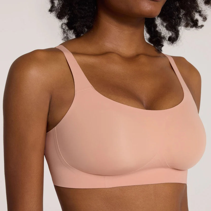 Woman wearing pink Evelyn & Bobbie Bobbie Scoop Bra in Himalayan Saltagainst a plain background well heeled boutique stowe vt