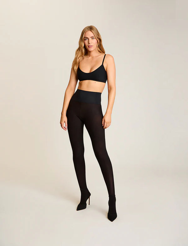 Woman wearing Commando The Ultimate Opaque Tights in Black on a white background well heeled