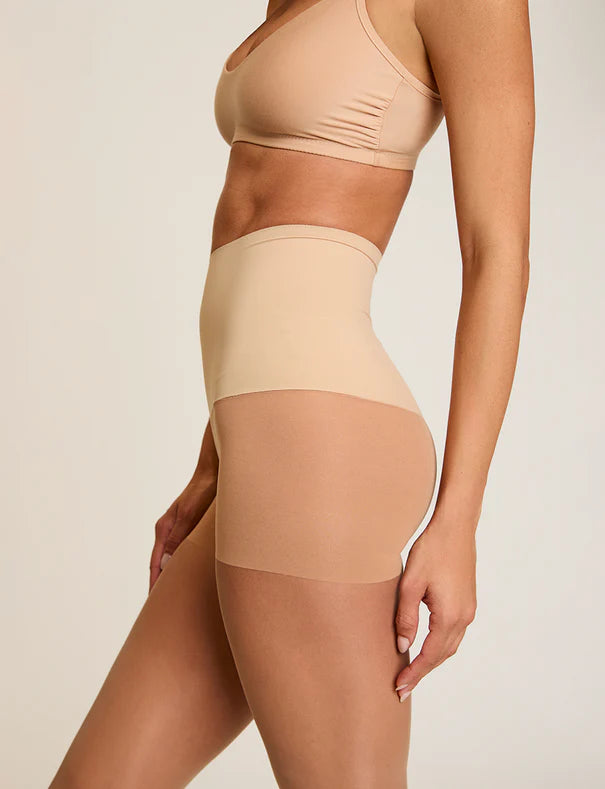 Woman wearing Commando The Keeper Sheer Control Tights in Medium Nude on a white background well heeled stowe vt