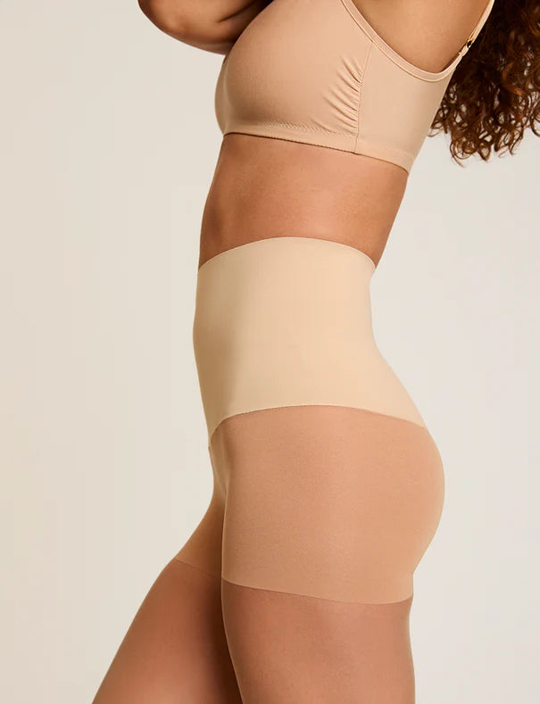 Woman wearing Commando The Keeper Sheer Control Tights in Medium Nude on a white background