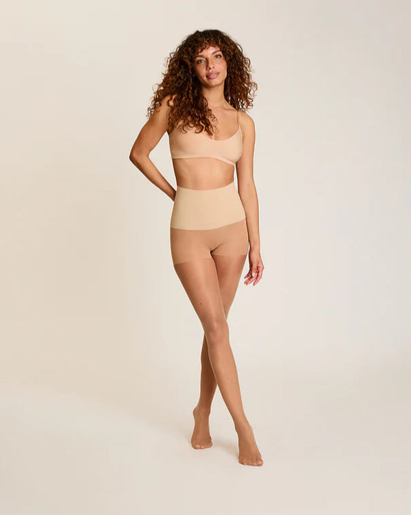 Woman wearing Commando The Keeper Sheer Control Tights in Medium Nude on a white background