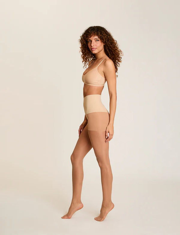 Woman wearing Commando The Keeper Sheer Control Tights in Medium Nude on a white background well heeled stowe vt