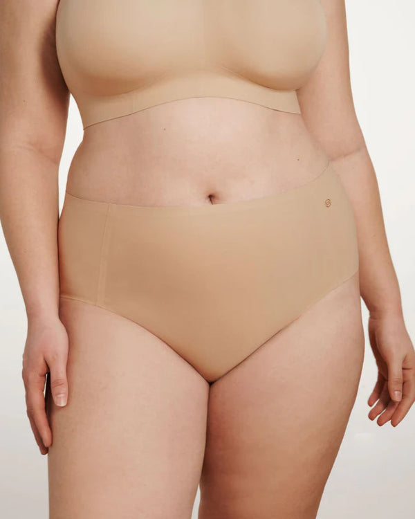woman wearing Evelyn & Bobbie High Waisted Retro Bikini in Sand on white background well heeled boutique stowe vt