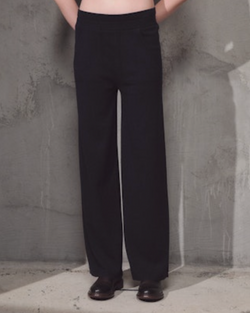 woman wearing Lamberto Losani Pantaloni in Dark Blue on grey wall well heeled vt