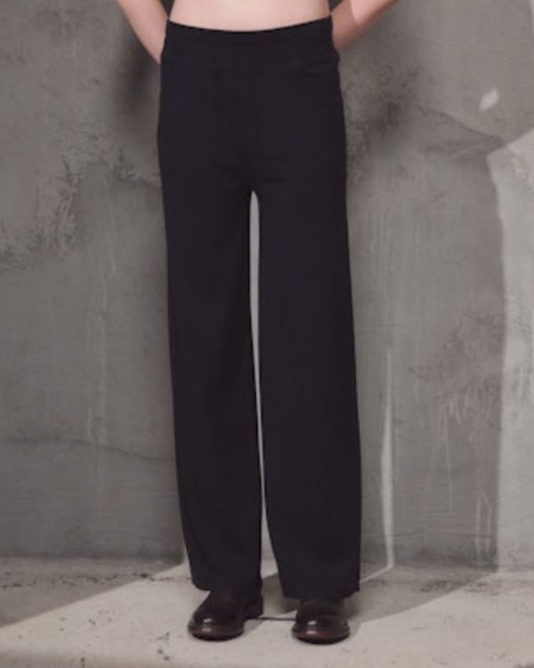 woman wearing Lamberto Losani Pantaloni in Dark Blue on grey wall well heeled vt