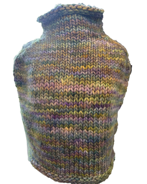 green and purple knitted poncho on a white background sold in stowe vermont